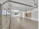 Spacious garage featuring white walls, painted floor and storage cabinets at 10471 Winghaven Dr, Noblesville, IN 46060