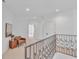 A brightly lit upstairs hallway with neutral walls and carpet at 10471 Winghaven Dr, Noblesville, IN 46060