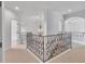 Upstairs hallway with decorative iron railing and elegant chandelier at 10471 Winghaven Dr, Noblesville, IN 46060