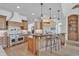 Spacious kitchen showcasing an eat-in island, custom cabinets, and a professional-grade range at 10471 Winghaven Dr, Noblesville, IN 46060