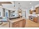 Open concept kitchen with a central island, granite countertops, and stainless steel appliances at 10471 Winghaven Dr, Noblesville, IN 46060