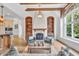 Cozy living room featuring a fireplace, built-in bookshelves, and vaulted ceilings with wood beams at 10471 Winghaven Dr, Noblesville, IN 46060