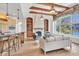Open-concept living room with kitchen island, fireplace, built-in shelves, and large windows at 10471 Winghaven Dr, Noblesville, IN 46060