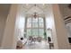 Bright living room featuring a large window, fireplace, and high ceiling at 10471 Winghaven Dr, Noblesville, IN 46060