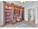 Spacious home office featuring custom wood bookshelves and stylish decor at 10471 Winghaven Dr, Noblesville, IN 46060