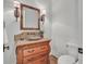 Elegant powder room features a vessel sink and decorative mirror and sconces at 10471 Winghaven Dr, Noblesville, IN 46060
