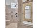 Beautifully tiled shower with multiple shower heads and a built-in bench at 10471 Winghaven Dr, Noblesville, IN 46060
