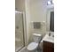 Standard bathroom with a shower and glass door, a white toilet, and a wood-accented sink at 108 Meadowview Dr, Mooresville, IN 46158