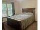 Comfortable bedroom with a large bed, neutral walls, and natural light at 108 Meadowview Dr, Mooresville, IN 46158