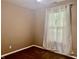Simple bedroom featuring a window with white curtains and neutral walls at 108 Meadowview Dr, Mooresville, IN 46158