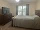 Bedroom featuring a wooden dresser, large bed, and natural light from the window at 108 Meadowview Dr, Mooresville, IN 46158