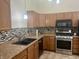 Modern kitchen with stainless steel appliances, mosaic backsplash and granite counters at 108 Meadowview Dr, Mooresville, IN 46158
