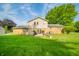 Expansive backyard with a lush lawn, patio, mature trees, and plenty of open space at 1111 Pendle Hill Ave, Pendleton, IN 46064