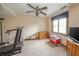 Well-lit bedroom featuring carpeted floors, a ceiling fan, a large window, and space for exercise equipment at 1111 Pendle Hill Ave, Pendleton, IN 46064