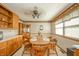 Inviting dining room featuring a round wood table, charming floral wallpaper, and a bright window at 1111 Pendle Hill Ave, Pendleton, IN 46064