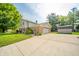 Exterior view of home showing a wide driveway leading to the attached garage and the shed in the backyard at 1111 Pendle Hill Ave, Pendleton, IN 46064