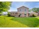 Charming front exterior featuring a well-maintained lawn and classic brick finishes at 1111 Pendle Hill Ave, Pendleton, IN 46064