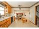 Kitchen featuring wood cabinets, a breakfast bar, and an open view to the adjoining living space at 1111 Pendle Hill Ave, Pendleton, IN 46064