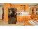Spacious kitchen with wood cabinets, black appliances, and ample counter space for meal preparation at 1111 Pendle Hill Ave, Pendleton, IN 46064
