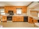 Functional kitchen boasting wood cabinets, modern appliances, and a convenient breakfast bar at 1111 Pendle Hill Ave, Pendleton, IN 46064