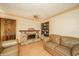 Comfortable living room showcasing a brick fireplace, built-in shelves, and cozy leather seating at 1111 Pendle Hill Ave, Pendleton, IN 46064