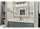 Bathroom vanity featuring modern fixtures, a decorative mirror, and storage at 11218 Baycreek Dr, Indianapolis, IN 46236