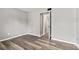 Neutral bedroom showcasing durable laminate wood flooring with an open doorway revealing the home's interior at 11218 Baycreek Dr, Indianapolis, IN 46236