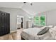 Bedroom with vaulted ceilings, laminate wood floors, and natural light from large windows at 11218 Baycreek Dr, Indianapolis, IN 46236