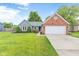 Charming home featuring a well-manicured lawn, brick accents, and attached two-car garage at 11218 Baycreek Dr, Indianapolis, IN 46236