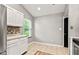 Kitchen featuring white cabinets, light countertops, tile flooring, and a window providing natural light at 11218 Baycreek Dr, Indianapolis, IN 46236