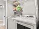 Functional laundry room with a new washer and dryer, plus storage shelving at 11218 Baycreek Dr, Indianapolis, IN 46236
