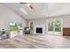 Living room featuring a fireplace, wood floors, and sliding glass doors to the backyard deck at 11218 Baycreek Dr, Indianapolis, IN 46236