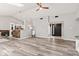 Spacious living area featuring wood floors, modern lighting, and an open flow into the kitchen at 11218 Baycreek Dr, Indianapolis, IN 46236
