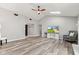 Bright, open living room with fireplace, skylight, and wood flooring, showing TV and furniture at 11218 Baycreek Dr, Indianapolis, IN 46236