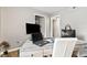 Home office featuring light walls, wood-look floors and modern wood-look desk with black hardware at 11218 Baycreek Dr, Indianapolis, IN 46236