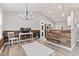 Open floor plan featuring an office, dining space, and a kitchen with modern lighting at 11218 Baycreek Dr, Indianapolis, IN 46236