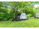 A storage shed sits in the backyard, providing ample space for tools and equipment, surrounded by lush greenery at 11218 Baycreek Dr, Indianapolis, IN 46236