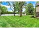 Large backyard with well-maintained lawn, shed, patio area, and mature trees at 116 Bennington Rd, Indianapolis, IN 46227