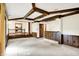 Finished basement with a stone fireplace, wood paneled walls, wood beams and sliding glass doors at 116 Bennington Rd, Indianapolis, IN 46227