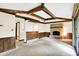 Finished basement with a stone fireplace, wood paneled walls, wood beams and sliding glass doors at 116 Bennington Rd, Indianapolis, IN 46227