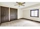Carpeted bedroom with ceiling fan, window with blinds, with access to the hallway at 116 Bennington Rd, Indianapolis, IN 46227