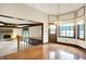 Open dining area features hardwood floors and access to a cozy living room with a stone fireplace at 116 Bennington Rd, Indianapolis, IN 46227