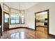 Light-filled dining area with hardwood floors and a chandelier, conveniently located near an open kitchen at 116 Bennington Rd, Indianapolis, IN 46227