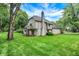 Charming home showcasing light siding and stone accents with an inviting backyard space at 116 Bennington Rd, Indianapolis, IN 46227