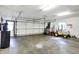 Spacious garage with two car garage door, overhead lighting, and water filtration system at 116 Bennington Rd, Indianapolis, IN 46227