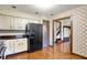 Traditional eat-in kitchen with wood cabinets, black appliances, and wooden floors at 116 Bennington Rd, Indianapolis, IN 46227