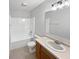 Well-lit bathroom with a vanity, sink, and bathtub/shower combination at 11722 Hartland Dr, Indianapolis, IN 46229