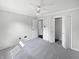 Spacious carpeted bedroom with ceiling fan and access to closet and hallway at 11722 Hartland Dr, Indianapolis, IN 46229