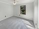 Cozy bedroom with soft carpeting, neutral walls, and a window view at 11722 Hartland Dr, Indianapolis, IN 46229