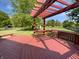 Inviting wooden deck with a pergola overlooking the yard and trees at 11722 Hartland Dr, Indianapolis, IN 46229
